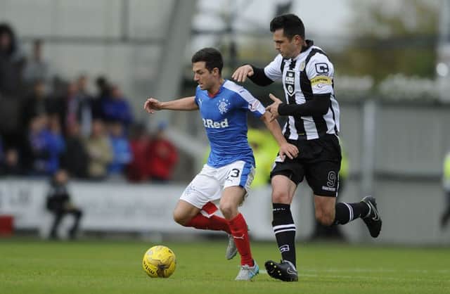 Rangers' Jason Holt and St Mirren's Steven Thompson battle for the ball. Picture: PA