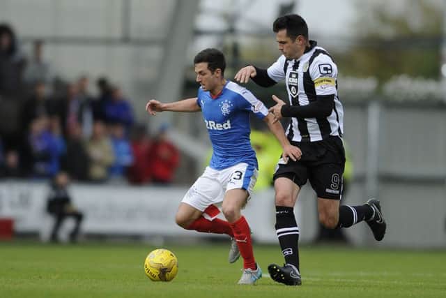 Rangers' Jason Holt and St Mirren's Steven Thompson battle for the ball. Picture: PA