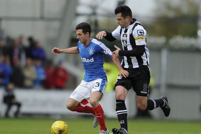 Rangers Jason Holt and St Mirren's Steven Thompson battle for the ball. Picture: PA