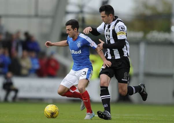 Rangers Jason Holt and St Mirren's Steven Thompson battle for the ball. Picture: PA