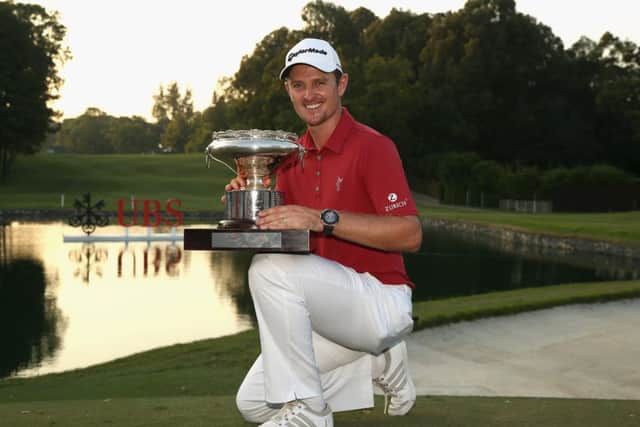 Justin Rose with the trophy after winning the Hong Kong Open, enjoying the luxury of being able to three-putt the last hole. Picture: Getty Images