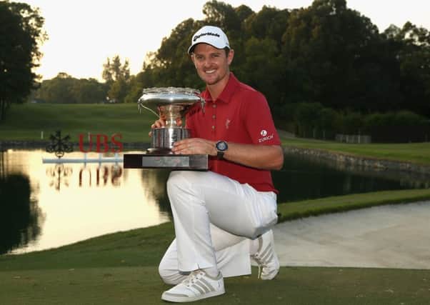 Justin Rose with the trophy after winning the Hong Kong Open, enjoying the luxury of being able to three-putt the last hole. Picture: Getty Images
