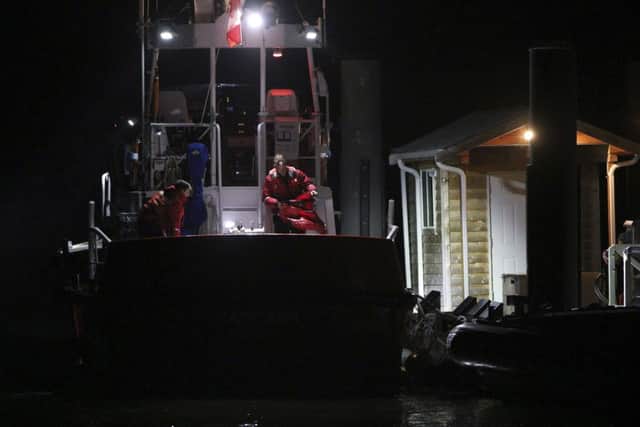 Canadian Coast Guard crew arrive at a dock in Tofino. Picture: AP
