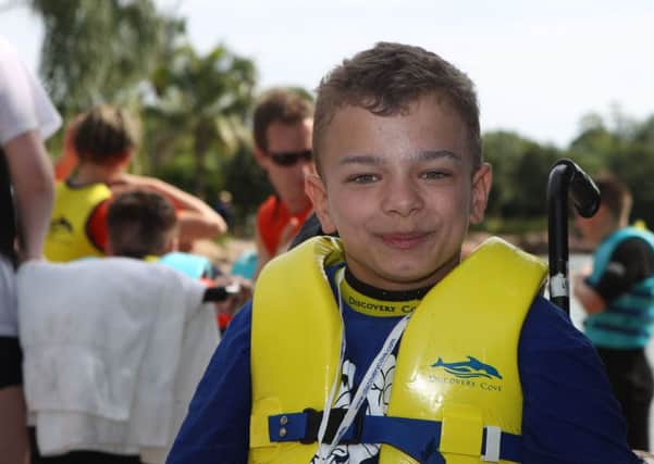 William Williamson from Coupar Angus in Scotland  before swimming with a dolphin at Discovery Cove in Orlando, Florida. Picture: Steve Parsons/PA Wire