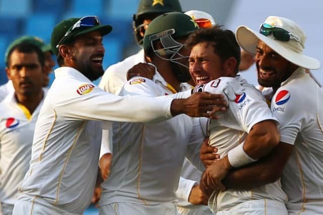 Pakistan's cricket players celebrate after dismissing England's Adil Rashid to win the second Test. Picture: Getty