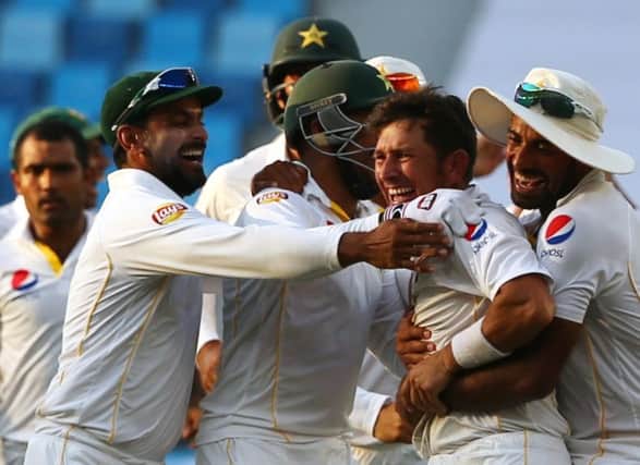 Pakistan's cricket players celebrate after dismissing England's Adil Rashid to win the second Test. Picture: Getty