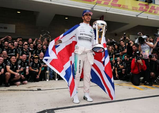 Lewis Hamilton celebrates his third Formula One world title. Picture: PA