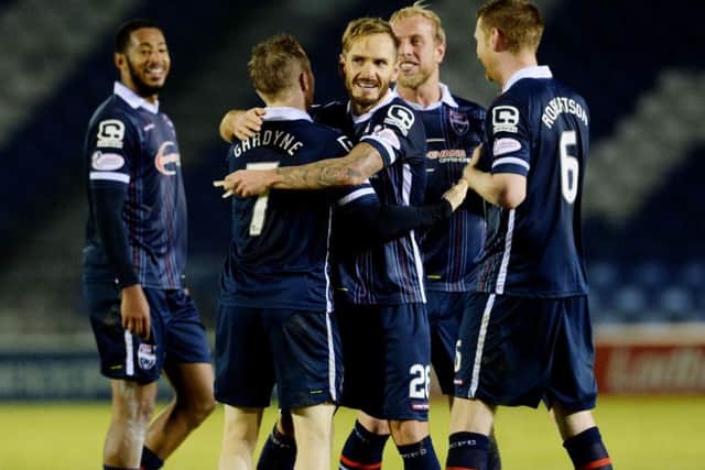Ross Countys Martin Woods, centre, celebrates his sides win with goalscorer Michael Gardyne. Picture: SNS Group