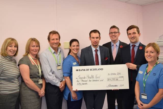From left to right, Judy Dixson, Debbie Archibald, Douglas Brown and Jo Allison with fundraisers Jack Boyle, Simon Allison and Andrew Wallace, flanked by Avril Gunning. Photo: NHS Tayside
