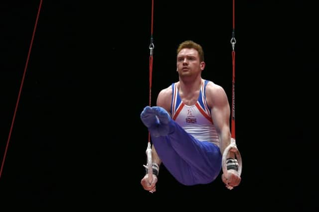 Britain's Dan Purvis performs on the rings during the men's team competition in Glasgow last night. Picture: AP