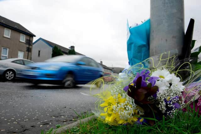 Tributes left in Greenock where a six-year-old boy died after being hit by a car as he crossed the road. Picture: Hemedia