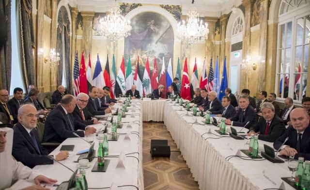 US Secretary of State John Kerry chats to Russian minister Sergey Lavrov at the summit. UK minister Philip Hammond is third from right. Picture: AFP/Getty