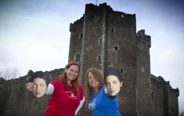 Outlander fans Jen Obirek, from Chicago, and Sinead Robertson, from Dublin, with their Claire Randall masks at Doune Castle earlier this year. Picture: Lloyd Smith