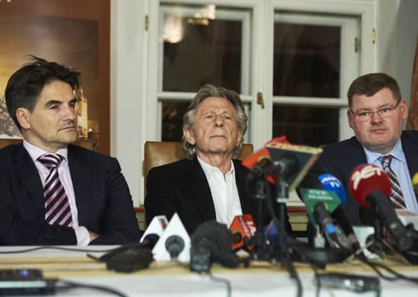 Roman Polanski, centre, with his lawyers, faces the press at the Bonarowski Palace Hotel in Krakow, Poland. Picture: Getty