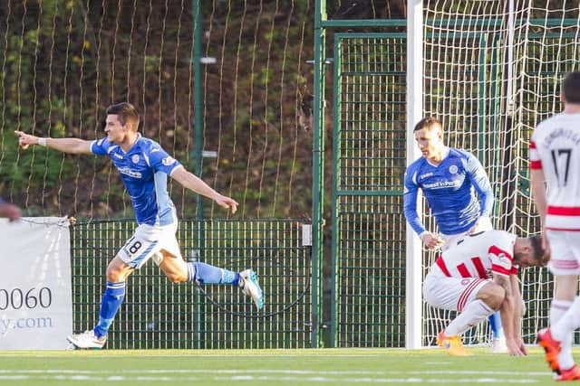 St Johnstone's Graham Cummins (left) wheels away to celebrate his goal. Picture: SNS