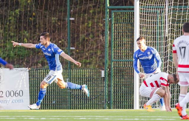 St Johnstone's Graham Cummins (left) wheels away to celebrate his goal. Picture: SNS