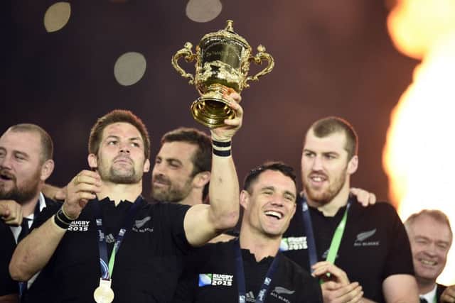 Richie McCaw raises the Web Ellis Cup as Dan Carter looks on. Picture: Getty