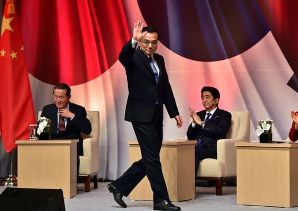 Chinese Premier Li Keqiang waves after addressing the summit in the South Korean capital Seoul. Picture: Getty