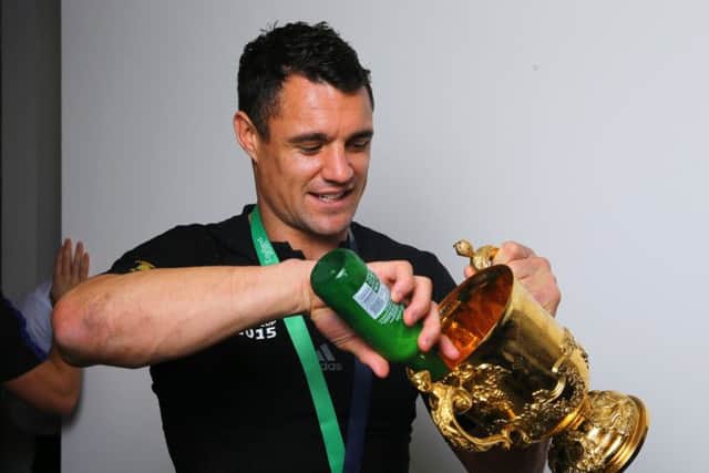 Dan Carter pours a beer into the Webb Ellis Cup. Picture: Getty