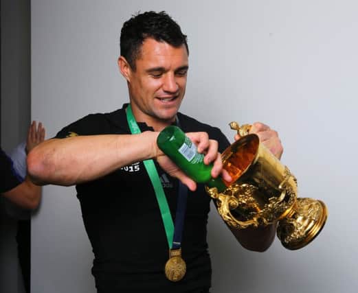 Dan Carter pours a beer into the Webb Ellis Cup. Picture: Getty