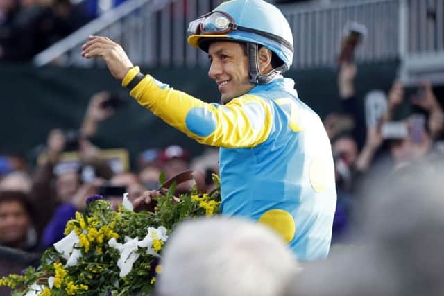 Jockey Victor Espinoza celebrates his win in the Breeders Cup Classic on American Pharoah. Picture: AP