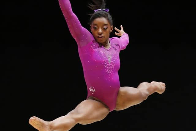 Simone Biles leaps to a record-breaking tenth world gold medal on the floor in Glasgow yesterday. Picture: PA