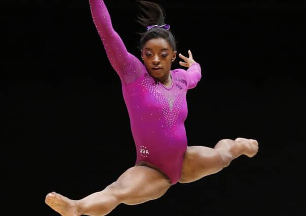 Simone Biles leaps to a record-breaking tenth world gold medal on the floor in Glasgow yesterday. Picture: PA