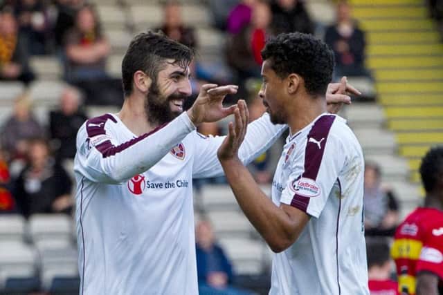 Hearts goalscorers Juanma, left, and Osman Sow celebrate during the thumping victory at Partick. Picture: SNS