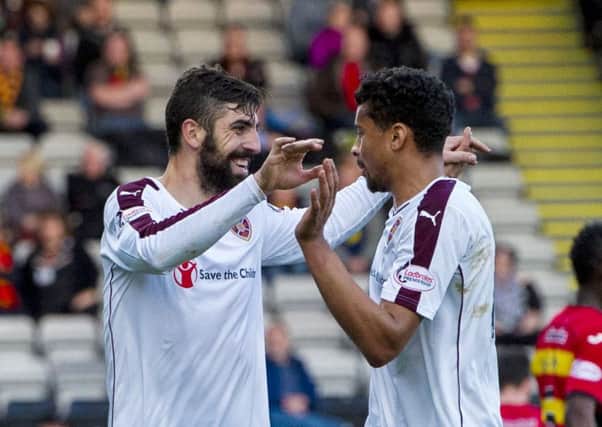 Hearts goalscorers Juanma, left, and Osman Sow celebrate during the thumping victory at Partick. Picture: SNS