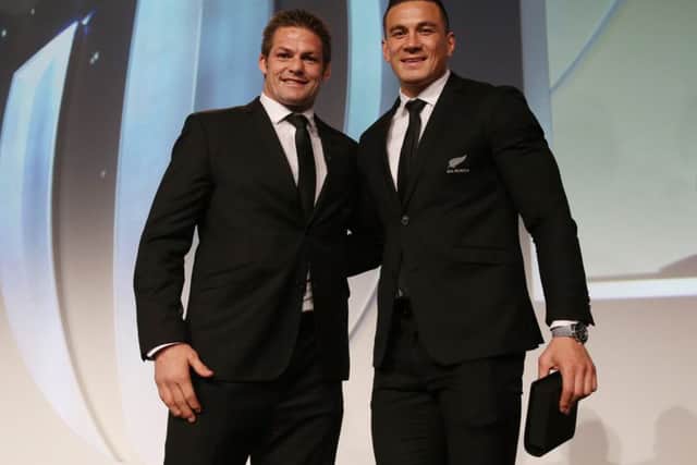 New Zealand captain Richie McCaw presents team-mate Sonny Bill Williams with his replacement World Cup winners medal. Picture: Getty