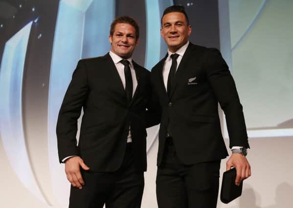 New Zealand captain Richie McCaw presents team-mate Sonny Bill Williams with his replacement World Cup winners medal. Picture: Getty