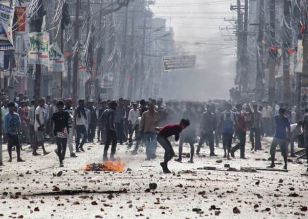 Ethnic Madhesi protesters throw stones and bricks at Nepalese police officers in Birgunj, Nepal. Picture: AP
