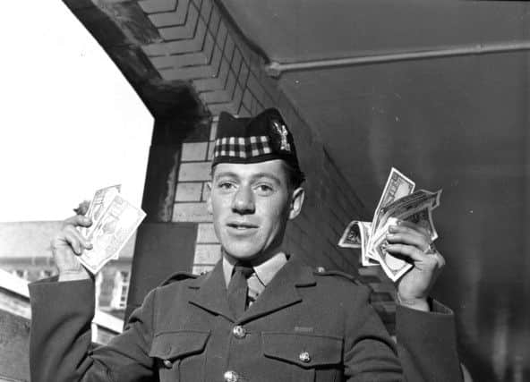 A soldier from the 1st Battalion Gordon Highlanders celebrates payday at Redford Barracks in Edinburgh, April 1966. Picture: TSPL