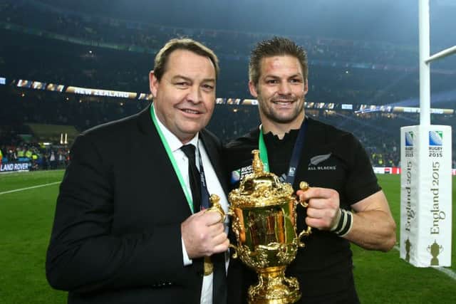New Zealand coach Steve Hansen, posing with Richie McCaw  and the Rugby World Cup, has a succession plan based on humility and constant improvement. Picture: Getty Images