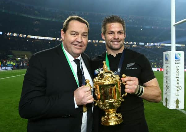 New Zealand coach Steve Hansen, posing with Richie McCaw  and the Rugby World Cup, has a succession plan based on humility and constant improvement. Picture: Getty Images