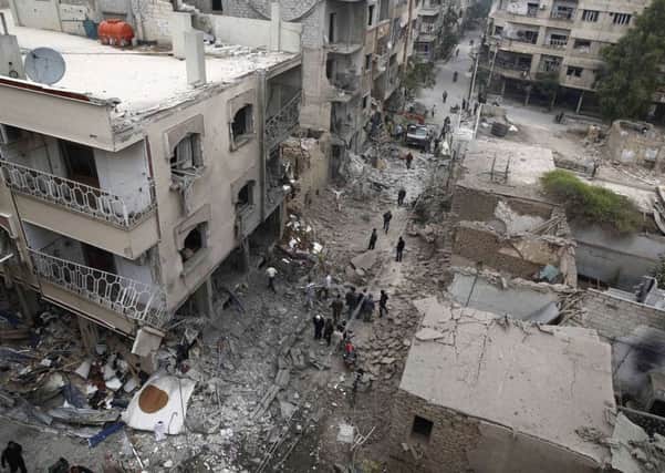 Damaged buildings following a reported air strike by Syrian government forces in the rebel-held area of Douma, east of the capital Damascus. Picture: AFP/Getty Images