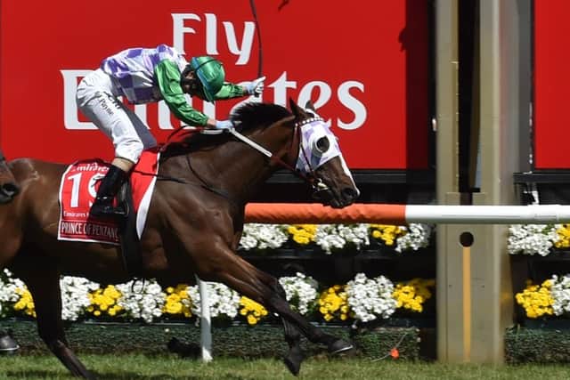 Jockey Michelle Payne crosses the line on Prince of Penzance to become the first female jockey to win a Melbourne Cup. Picture: AFP/Getty Images