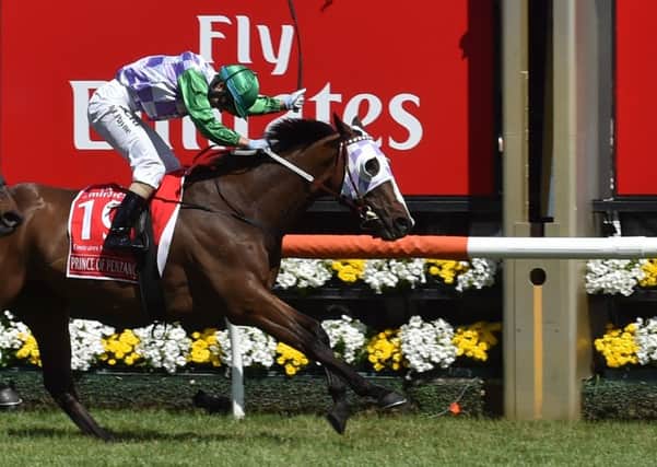 Jockey Michelle Payne crosses the line on Prince of Penzance to become the first female jockey to win a Melbourne Cup. Picture: AFP/Getty Images