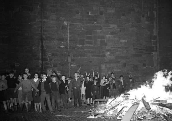 Bonfire watched by children in Dumbiedykes - Holyrood area Edinburgh, 1956. Guy Fawkes night.