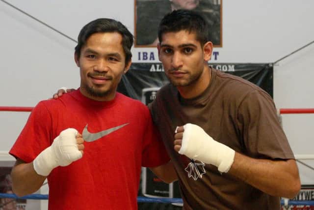 Manny Pacquiao and Amir Khan (right) who have agreed in principle to a lucrative welterweight fight. Picture: PA