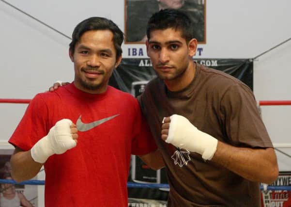 Manny Pacquiao and Amir Khan (right) who have agreed in principle to a lucrative welterweight fight. Picture: PA