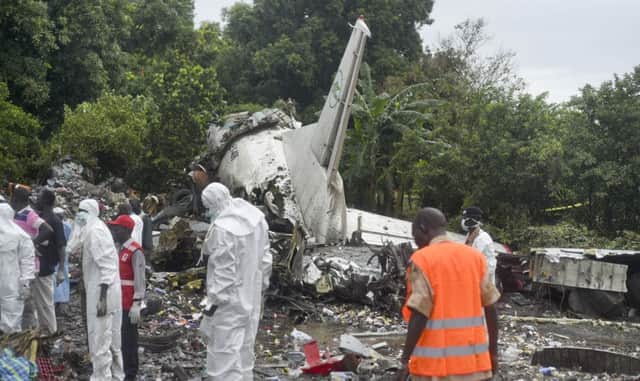 Emergency crews pick through the wreckage of the cargo plane which came down in South Sudan yesterday. Picture: AP