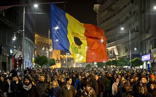 Romanians attend a rally in the Calea Victoriei, a main avenue of the capital Bucharest, to protest at widespread government corruption. Picture: AP