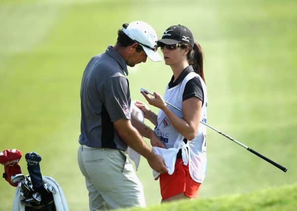 Peter Whiteford with his wife and caddie, Gabby, during his first-round 73 in Muscat, Oman. Picture: Getty