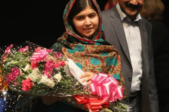 Malala Yousafzai stands with her father Ziauddin. Picture: Getty Images