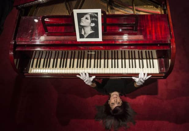 Lyon & Turnbull's Hannah Willets models the Krakauer baby piano that once belonged to Barbra Streisand. Picture: Phil Wilkinson