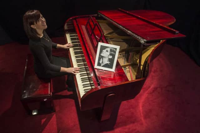 Lyon & Turnbull's Hannah Willets models the Krakauer baby piano that once belonged to Barbra Streisand. Picture: Phil Wilkinson