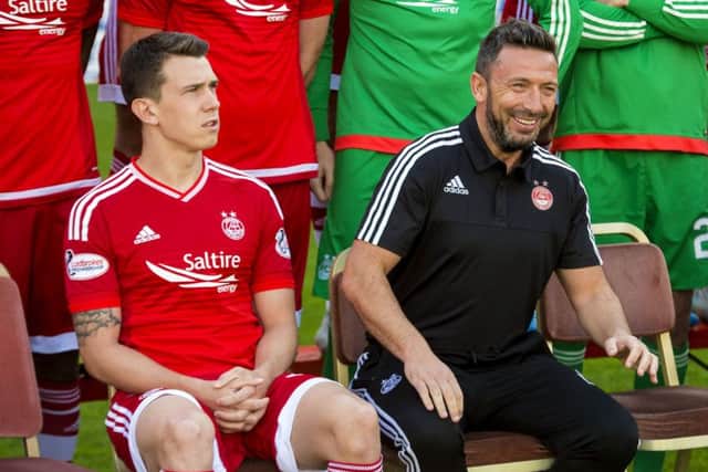 Aberdeen captain Ryan Jack sits alongside manager Derek McInnes earlier in the season. Jack dismissed talk of a rift between them. Picture: SNS Group