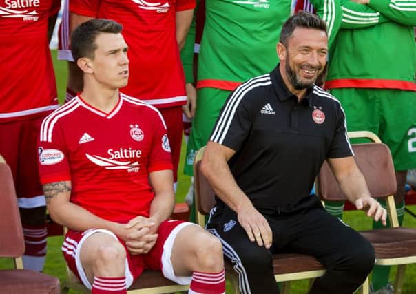 Aberdeen captain Ryan Jack sits alongside manager Derek McInnes earlier in the season. Jack dismissed talk of a rift between them. Picture: SNS Group