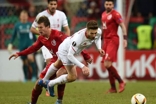 Maksim Kanunnikov (left) is challenged by Liverpool's Joe Allen in Moscow. Picture: Getty Images